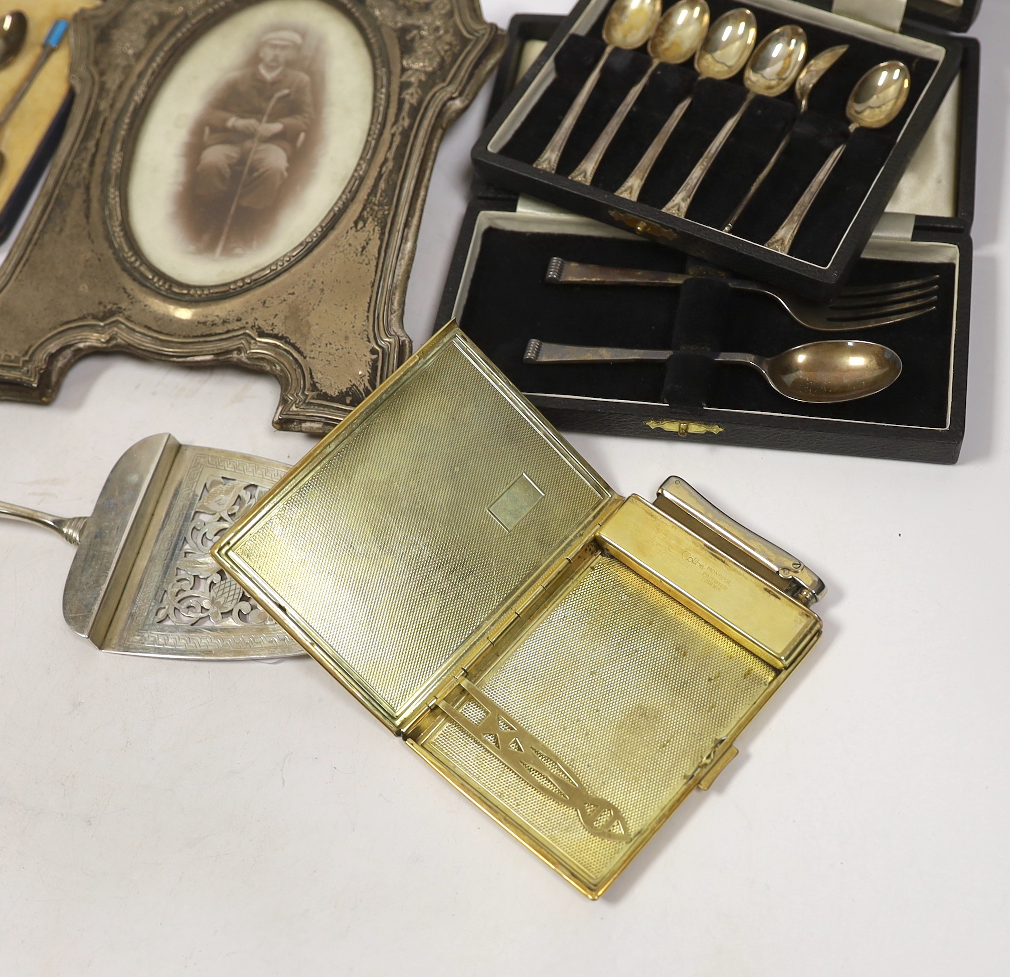 Miscellaneous items including three cased sets of silver flatware including enamelled teaspoons, Halcyon Days boxes, cased barometer, gilt metal case, silver mounted photograph frame, etc.